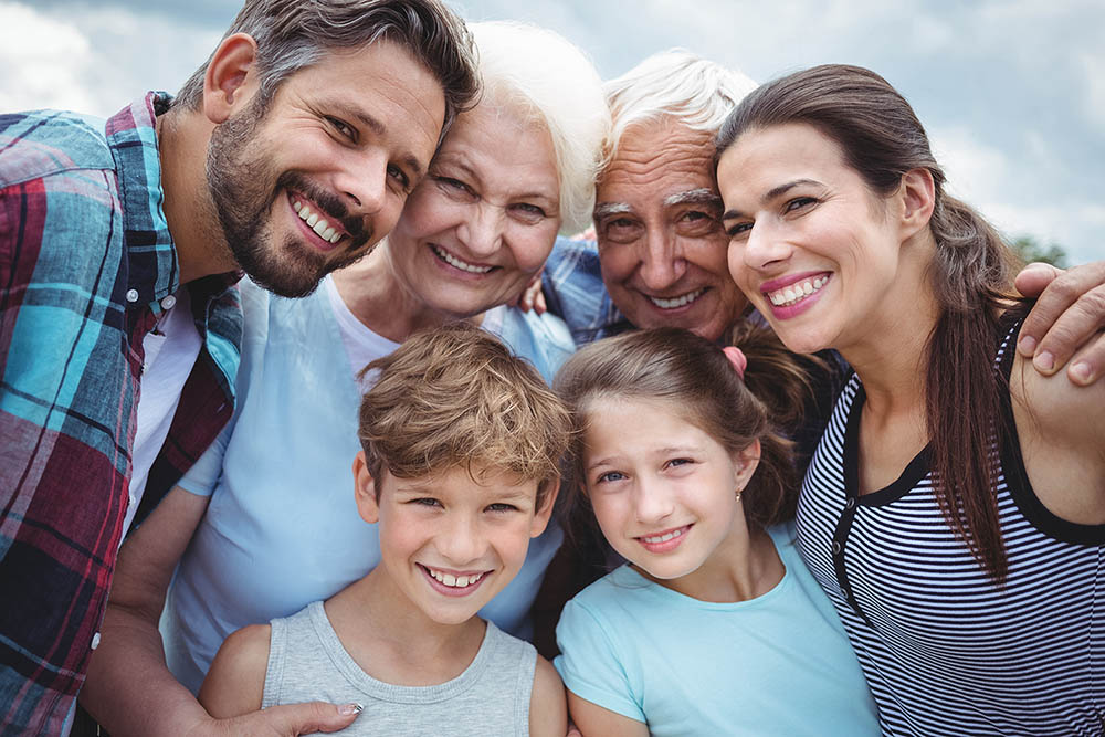 Image of family including 3 generations: gandparents, parents and 2 kids (a boy and a girl) - Ryan Family Law